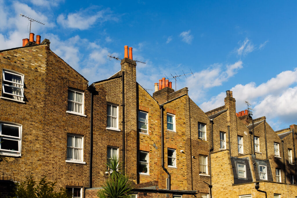 Terraced Brick Houses With Chimneys And Antennas U